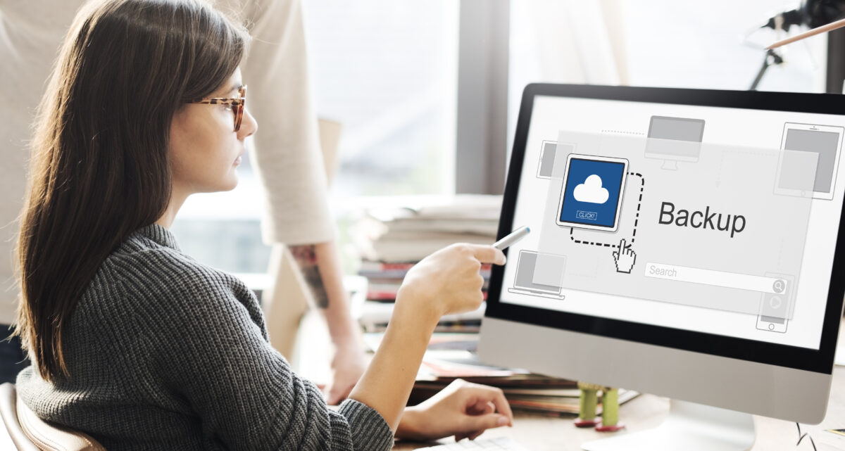 Lady using data backup solution on laptop